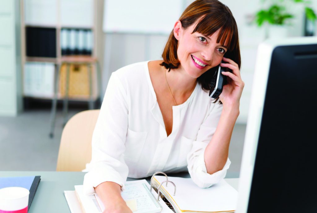 Woman taking a call on her home phone line